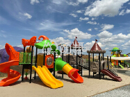Kids play area with several outdoor playground equipment in amusement park